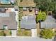An aerial view of a home showcasing its backyard, neighboring houses, and surrounding green trees at 9126 Greenbriar Ln, Port Richey, FL 34668