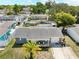 Aerial view of a single Gathering home featuring a well maintained roof, and a lush tree canopy at 9126 Greenbriar Ln, Port Richey, FL 34668