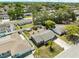 Aerial view showcasing the home's layout, including the fenced backyard, landscaping, and surrounding neighborhood at 9126 Greenbriar Ln, Port Richey, FL 34668