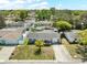 An aerial view of a well-maintained single-story home featuring a front yard with a palm tree and a long driveway at 9126 Greenbriar Ln, Port Richey, FL 34668