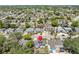 An aerial view showing the neighborhood and the property with a red marker on top at 9126 Greenbriar Ln, Port Richey, FL 34668