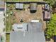 Expansive aerial view showcases a large backyard featuring multiple outbuildings and patio space at 9126 Greenbriar Ln, Port Richey, FL 34668