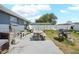 Relaxing backyard features a concrete patio, a picnic table, and a grill perfect for outdoor gatherings at 9126 Greenbriar Ln, Port Richey, FL 34668