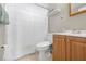 Bathroom featuring white shower curtain, toilet, and light wood vanity with white sink and chrome faucet at 9126 Greenbriar Ln, Port Richey, FL 34668