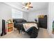 Bright bedroom features light-colored flooring, a ceiling fan, and a sunlit window for a refreshing space at 9126 Greenbriar Ln, Port Richey, FL 34668