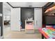 A bedroom with a bunk bed, storage for toys and a view into the living room, has a large black wall at 9126 Greenbriar Ln, Port Richey, FL 34668