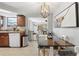 Dining area featuring tile floors and view into the kitchen with wood cabinets and stainless appliances at 9126 Greenbriar Ln, Port Richey, FL 34668