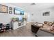 Inviting living room with comfortable seating, a TV, and a modern white cabinet at 9126 Greenbriar Ln, Port Richey, FL 34668