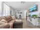 Cozy living room with comfortable seating, a modern TV, and vinyl flooring at 9126 Greenbriar Ln, Port Richey, FL 34668