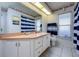 Bathroom featuring a single vanity, white cabinets and a window at 10149 Briar Cir, Hudson, FL 34667