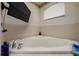 Large soaking tub in the bathroom under a window at 10149 Briar Cir, Hudson, FL 34667
