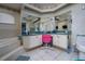 Bathroom with dual sinks, white cabinets, and a large mirror at 10149 Briar Cir, Hudson, FL 34667