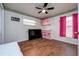 Bright bedroom features wood-look tile, ceiling fan, and pink accents at 10149 Briar Cir, Hudson, FL 34667