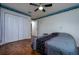 Bedroom features wood-look flooring, ceiling fan, and closet at 10149 Briar Cir, Hudson, FL 34667