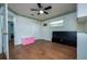 Bedroom with wood-look tile, ceiling fan, and closet at 10149 Briar Cir, Hudson, FL 34667