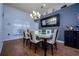 Elegant dining area features a modern chandelier and a sleek table set for six at 10149 Briar Cir, Hudson, FL 34667