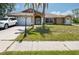Charming one story home featuring a well-manicured lawn and inviting double door entry at 10149 Briar Cir, Hudson, FL 34667