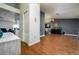 Spacious living area showcasing elegant wood-look floors connecting to the dining and kitchen spaces at 10149 Briar Cir, Hudson, FL 34667