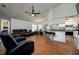 Open living space flows into the kitchen, complete with a ceiling fan and bar seating at 10149 Briar Cir, Hudson, FL 34667
