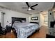 Spacious main bedroom with dark wood floors, king size bed, TV and adjoining bathroom at 10149 Briar Cir, Hudson, FL 34667
