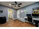 Home office features wood-look flooring and a modern desk at 10149 Briar Cir, Hudson, FL 34667