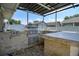 Outdoor kitchen with built-in grill, counter, and stone accents at 10149 Briar Cir, Hudson, FL 34667