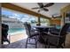 Covered patio with outdoor dining area and view of the pool at 10149 Briar Cir, Hudson, FL 34667