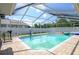 Sparkling in-ground pool with screened enclosure and brick patio at 10149 Briar Cir, Hudson, FL 34667