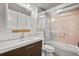 Bathroom featuring shower-tub combo, patterned ceiling, sink vanity and decorative accents at 1021 15Th St, Palm Harbor, FL 34683