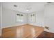 View of the bedroom featuring shuttered windows, ceiling fan, and laminate wood floors at 1021 15Th St, Palm Harbor, FL 34683