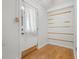 View of the entryway showcasing the front door with glass and wood laminate flooring at 1021 15Th St, Palm Harbor, FL 34683
