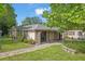 Exterior of home featuring a brick walkway and well-maintained landscaping at 1021 15Th St, Palm Harbor, FL 34683