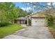 Home's exterior, showing an attached garage and in-law suite at 1021 15Th St, Palm Harbor, FL 34683