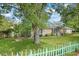 Quaint single-story home with lush front yard and decorative picket fence at 1021 15Th St, Palm Harbor, FL 34683