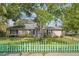 Charming single-story home with lush lawn, mature trees and adorable decorative picket fence at 1021 15Th St, Palm Harbor, FL 34683