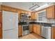 Eat-in kitchen featuring stainless steel appliances, wood cabinets and hard surface countertops at 1021 15Th St, Palm Harbor, FL 34683