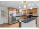 Well-lit kitchen features stainless steel appliances, light wood cabinets, and dark countertops at 1021 15Th St, Palm Harbor, FL 34683