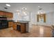 Open concept kitchen featuring wood cabinets, dark countertops, and hardwood floors at 1021 15Th St, Palm Harbor, FL 34683