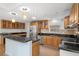 Bright kitchen featuring stainless appliances, wood cabinets, dark counters and an island with seating at 1021 15Th St, Palm Harbor, FL 34683