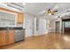 Open living space and kitchen area with wood laminate floors and stainless steel appliances at 1021 15Th St, Palm Harbor, FL 34683