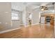 View of the living room and kitchen featuring laminate floors, ceiling fan, and natural light at 1021 15Th St, Palm Harbor, FL 34683