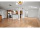 Open concept living space featuring a kitchen, hardwood floors, and ample natural light at 1021 15Th St, Palm Harbor, FL 34683