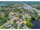 Overhead view of the property in a lovely neighborhood surrounded by a lake and mature trees at 10408 Butia Pl, Tampa, FL 33618