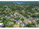 Aerial view of the property nestled in a tranquil neighborhood surrounded by trees and lake at 10408 Butia Pl, Tampa, FL 33618