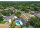 Aerial view of the property surrounded by mature trees in a tranquil neighborhood with a backyard pool at 10408 Butia Pl, Tampa, FL 33618