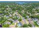 Overhead shot of the home, situated in a neighborhood surrounded by mature trees and lush landscaping at 10408 Butia Pl, Tampa, FL 33618