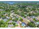 Aerial view of the property in a beautiful neighborhood surrounded by lakes, mature trees, and lush landscaping at 10408 Butia Pl, Tampa, FL 33618