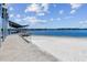 Picturesque beach view with pier and calm waters, perfect for a relaxing day at 10408 Butia Pl, Tampa, FL 33618