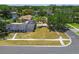 An aerial shot displays a home with a large yard, surrounded by lush trees and a serene lake at 10408 Butia Pl, Tampa, FL 33618
