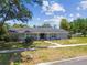 Charming single story brick home featuring a well maintained lawn and sidewalk entrance at 10408 Butia Pl, Tampa, FL 33618